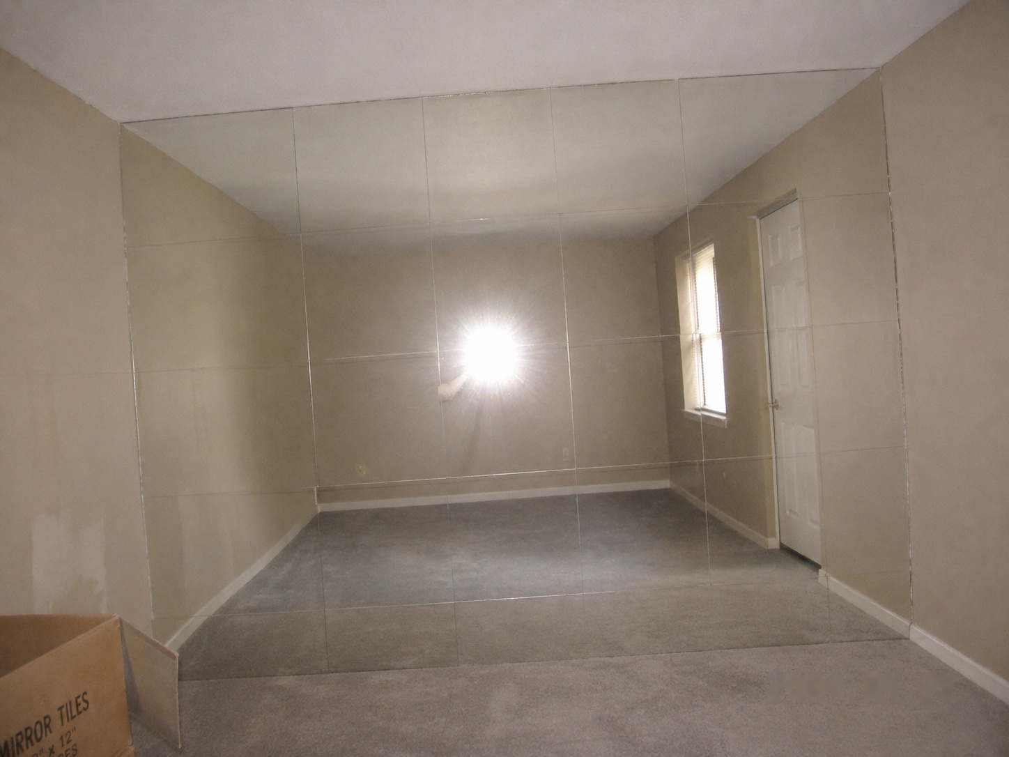 The goal: a finished seamless mirror-tile wall — hairline joints, one continuous reflection.