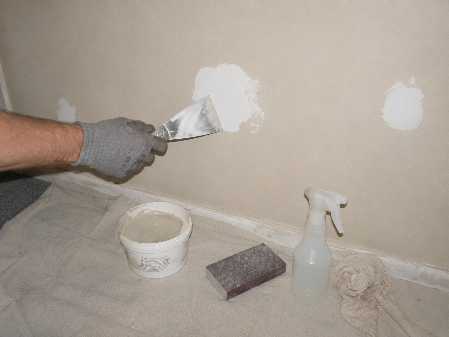 Patch, sand, clean: the unglamorous step every good wall stands on.